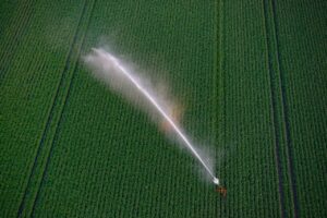 pexels-photo-33116756-33116756 Aerial photograph of an irrigation system watering a green field in Drenthe, Netherlands.